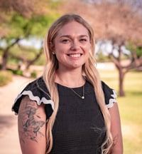 A headshot of Halie Sade in front of a park