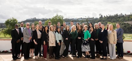 Group photo of leadership outside a hotel in California