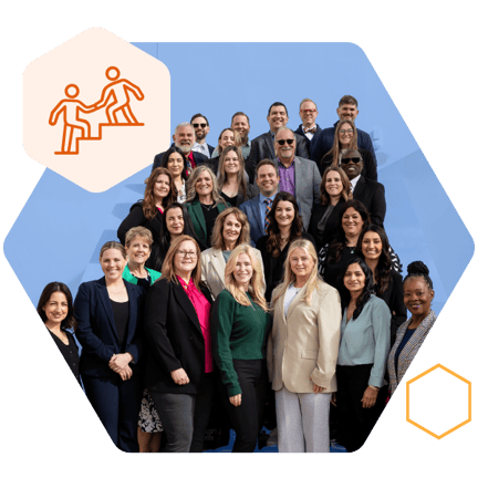 A large group of staff members standing together and smiling for a group photo