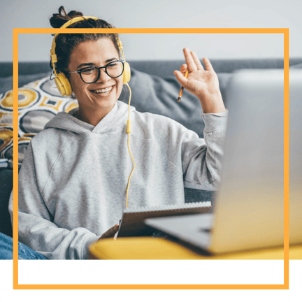 young student waving to people on remote meeting